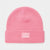 A pink knit beanie hat with a folded cuff, featuring a small rectangular patch on the front that reads 'I AM A UNICORN!' in white text with small white star details.