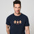 A man wearing a navy blue crewneck t-shirt with a graphic of three gingerbread men and the text 'oh well.
