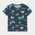 A navy blue short-sleeve t-shirt with a light blue and white video game theme print, featuring retro arcade characters, game controllers, and text like 'GAME OVER?' and 'PRESS START'.