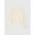 A long-sleeve cropped knit top in a warm cream or off-white color, displayed flat against a light gray background.
