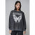 A woman modeling a dark gray washed crewneck sweatshirt with a large white graphic print of a butterfly and the word 'FLAWLESS' on the front, set against a plain gray studio background.