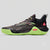 A single athletic sneaker shown in profile against a light gray background. The shoe has a black and dark gray textured upper with subtle pink and green accents, a black heel, and a bright neon green sole.