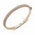 A rose gold bangle bracelet with a pavé-set row of clear crystals on the outer band, shown on a clean white background. The brand name 'DKNY' is visible inside the band.