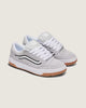 Pair of gray sneakers with white laces on a light beige background