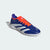 Blue and orange athletic shoe with white stripes on a light gray background