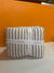 Folded fabric with 'LevTex Home' label against an orange background