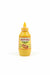 Hand holding a bottle of White Bell Mustard with a blurred background