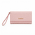 A light pink textured clutch wallet with a matching wristlet strap and a gold-tone 'babe' logo on the front, set against a plain white background.