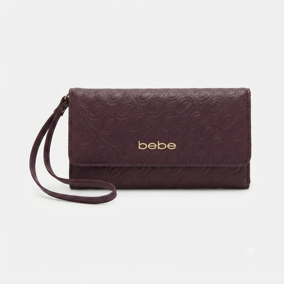 A dark plum purple embossed leather clutch bag with a wrist strap and gold 'bebe' logo on the front, set against a plain light gray background.