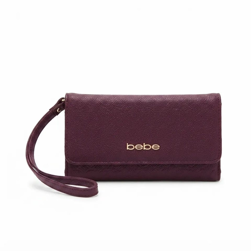 A dark plum purple textured leather wristlet clutch with a gold 'bebe' logo on the front, shown on a plain white background.