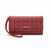 A burgundy leather clutch wallet with an allover tonal 'bebe' logo pattern and a gold-tone 'bebe' logo on the front, featuring a matching wristlet strap, set against a plain white background.
