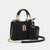 A black textured leather handbag with gold-tone hardware, featuring top handles, a detachable shoulder strap with chain links, a front gold letter B emblem, and a matching black card holder pouch with gold branding.