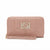 A dusty pink quilted zip-around wallet with a matching wristlet strap and a rhinestone-embellished 'HS' logo on the front, set against a plain white background.
