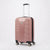 A pink hard-shell spinner suitcase with a textured vertical rib design, a silver telescoping handle, and four multi-directional wheels, shown on a light gray background.