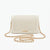An off-white woven leather crossbody bag with a gold-tone chain strap and a gold 'bebe' logo on the front, displayed on a clean white background.