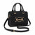 A black leather handbag with gold-tone hardware, featuring a top handle, a detachable shoulder strap, and a prominent oval buckle on the front with the brand name 'bebe!' in gold lettering, set against a plain white background.