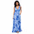 A woman modeling a sleeveless, V-neck maxi dress with a blue and white floral watercolor pattern, set against a plain white background.