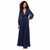 A woman modeling a navy blue maxi dress with a deep V-neckline, sheer long balloon sleeves, a lace-embroidered waist, and a flowing pleated skirt, set against a plain white background.