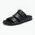 A single black leather slide sandal with three wide horizontal straps and a low black sole, featuring a small embossed CK logo on the heel, shown against a plain white background.