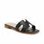 A black leather slide sandal with a cutout H-strap design, shown from a three-quarters angle on a white background. The brand name 'JENNIE STRAY' is visible on the insole.