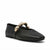 A black leather Mary Jane flat shoe with a pointed toe and a decorative gold-tone metal bow detail across the instep, shown against a plain white background.