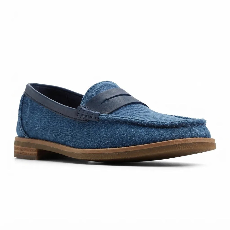 A single blue suede penny loafer shoe with a brown stacked sole, shown from a three-quarters angle on a white background.