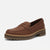 A brown leather penny loafer with a chunky brown platform sole, shown from a three-quarters angle on a light gray background.