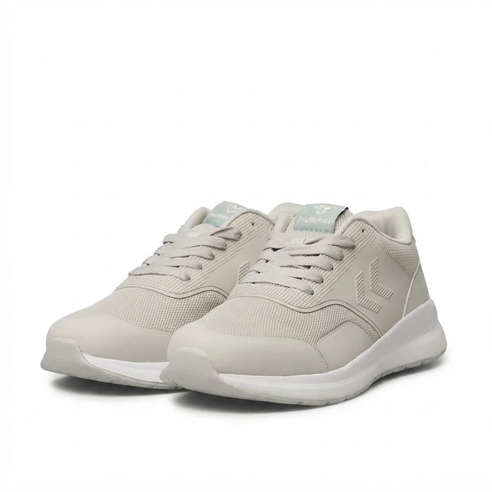 A pair of light beige athletic sneakers with white soles, shown from a three-quarters angle on a white background.