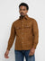 Man wearing a brown shirt with two front pockets on a white background