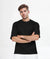 Man wearing a black t-shirt against a white background
