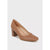 A single women's pump shoe in smooth tan leather with a chunky stacked block heel, shown from a three-quarters angle on a light gray background.