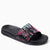 A single slide sandal with a black sole and strap, featuring a vibrant abstract pattern in hot pink and light blue on the upper strap, shown against a plain white background.