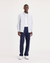 Man wearing a white shirt and navy pants on a white background