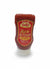 A bottle of Dolly's Hot Ketchup Upside Down with a red label, predominantly red ketchup visible through the clear plastic, and a white cap.