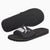 Black Puma slide sandals with a white logo, showing both the top strap design and the textured sole.