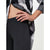 Close-up of a model wearing dark charcoal gray heathered leggings and an open black, white, and gray plaid shirt, with one hand resting on the hip.
