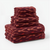 Stack of red patterned towels on a white background