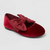Red velvet flat shoe with a bow on a light gray background
