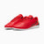 A pair of red Scuderia Ferrari low-top sneakers with perforated side panels, black accents, and a white sole, displayed on a clean white background.