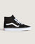 Black high-top sneaker with white laces on a light beige background