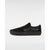 A black low-top skate shoe with a suede-like finish, black laces, and a black rubber sole, shown in profile against a light gray background.