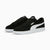 Pair of black and white Puma sneakers on a light gray background