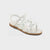 Silver sandal with a brown sole on a white background
