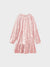 Pink textured dress on a light gray background