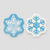 Two snowflake-shaped felt pieces on a light gray background, one light blue with a white snowflake design and the other white with a blue snowflake design.