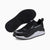 Black and white sneakers with a visible brand logo on a white background