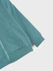 Teal sweatshirt with a pocket on a light gray background