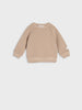 Beige sweater on a light gray background
