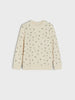 Beige long-sleeve shirt with small black pattern on a white background