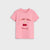 A pink short-sleeve crewneck t-shirt for kids, featuring a graphic on the front with the text 'I LOVE YOU' and 'Cherry much' in a retro font, accompanied by a red cherry illustration.